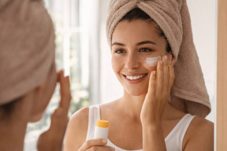 Woman applying sunscreen in the morning